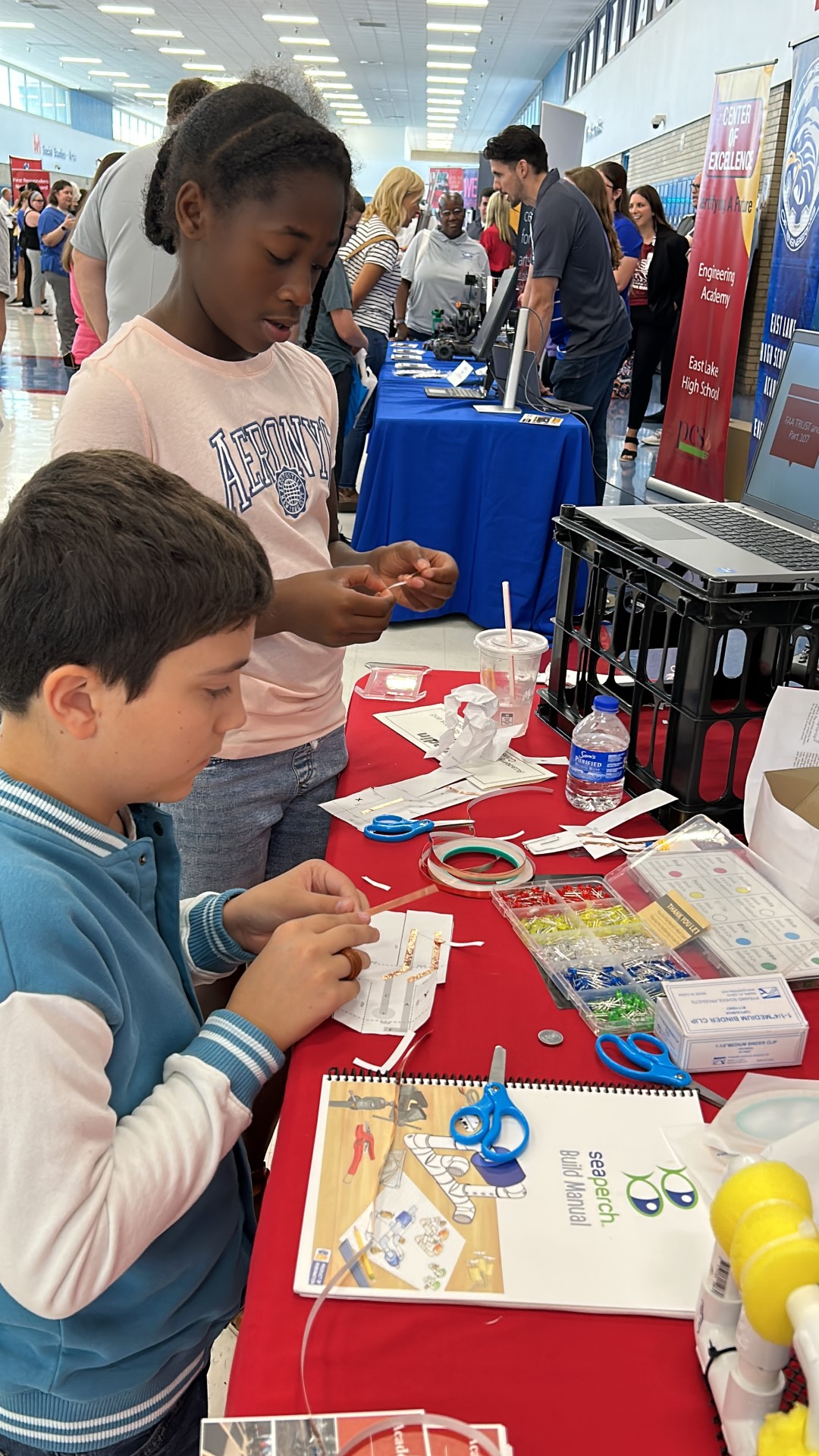 A group of kids working on paper craftDescription automatically generated